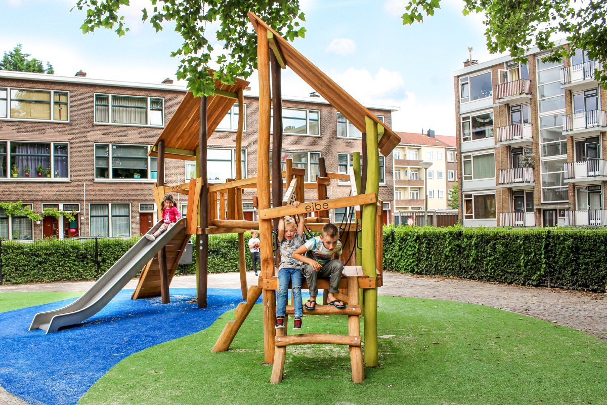 Public playgrounds - children playing on eibe play equipment in an inner-city green space.