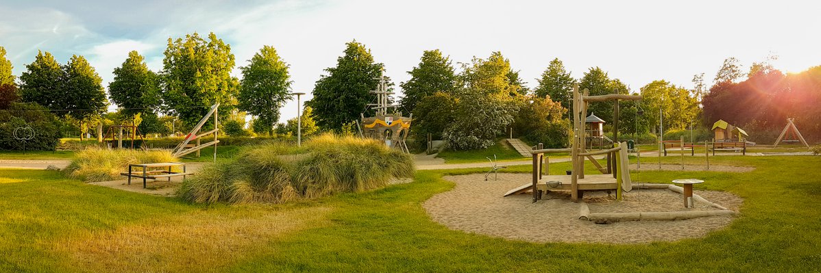 Playground architecture with eibe - eibe play structure on a large green area.