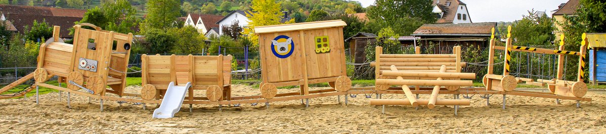 Playground equipment for childcare facilities from eibe - play structure in the shape of a wooden railway in the outdoor area of a childcare facility.