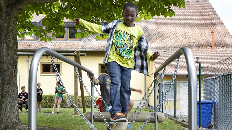 School playground planning – children balancing on eibe play equipment in the School playground.