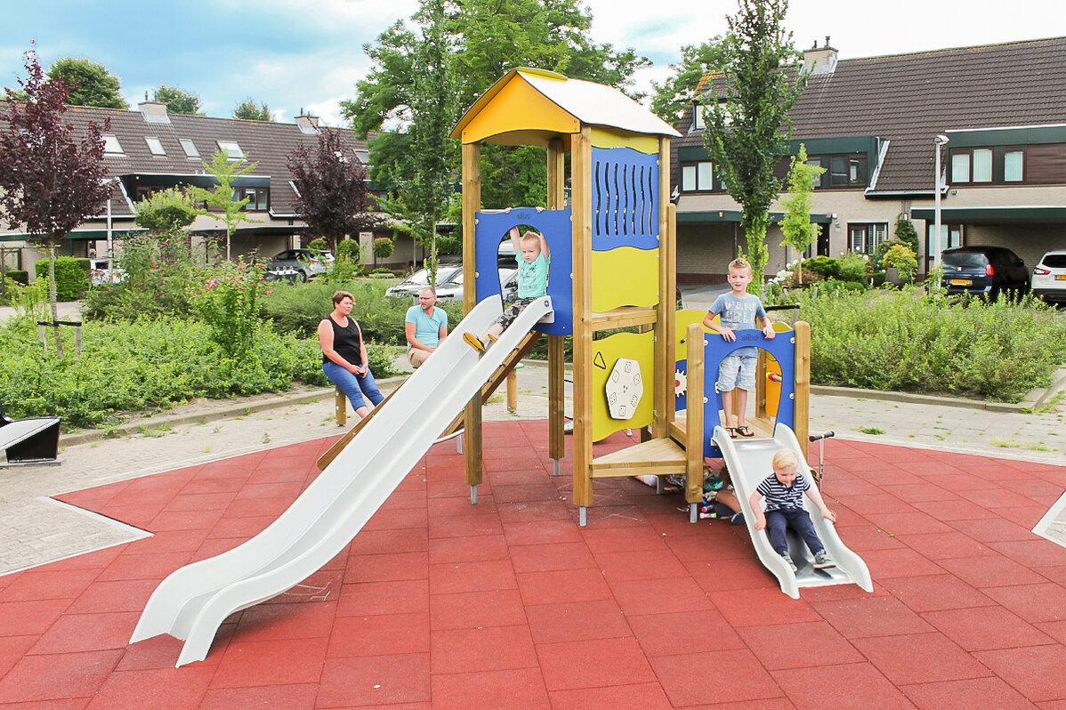Playgrounds for housing estates - small children playing on playground equipment from eibe.